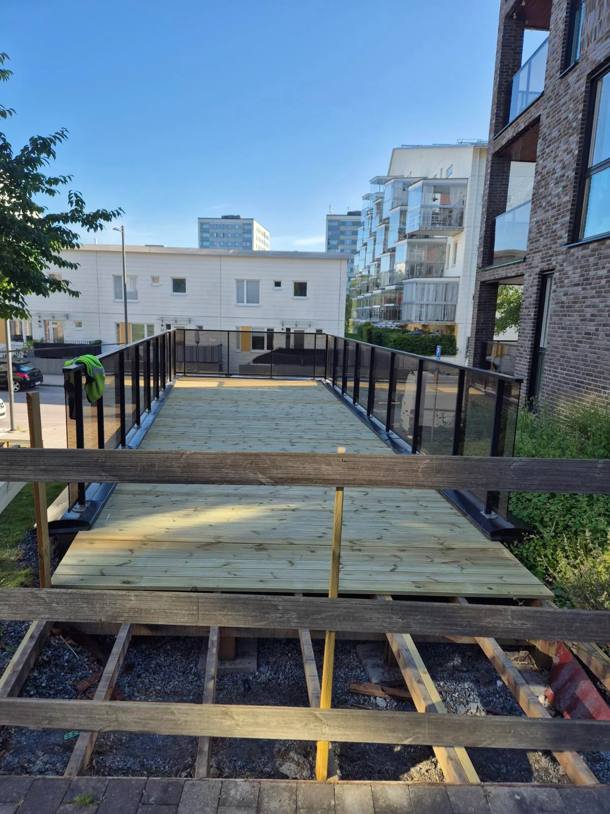 Nybyggnation av altan med trätrall och räcke i bostadsområde